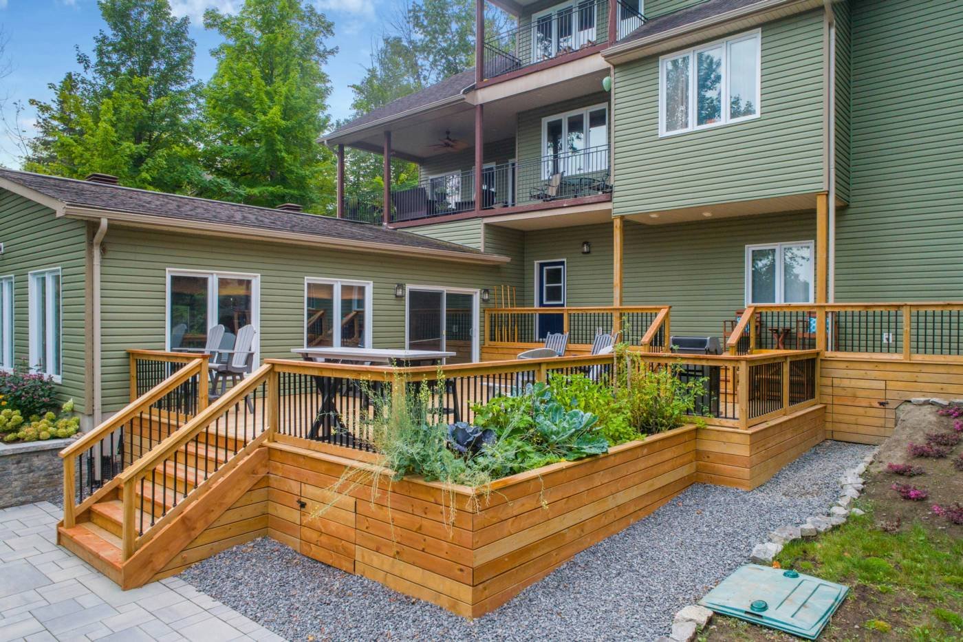 A raised timber deck with steps and built-in planters