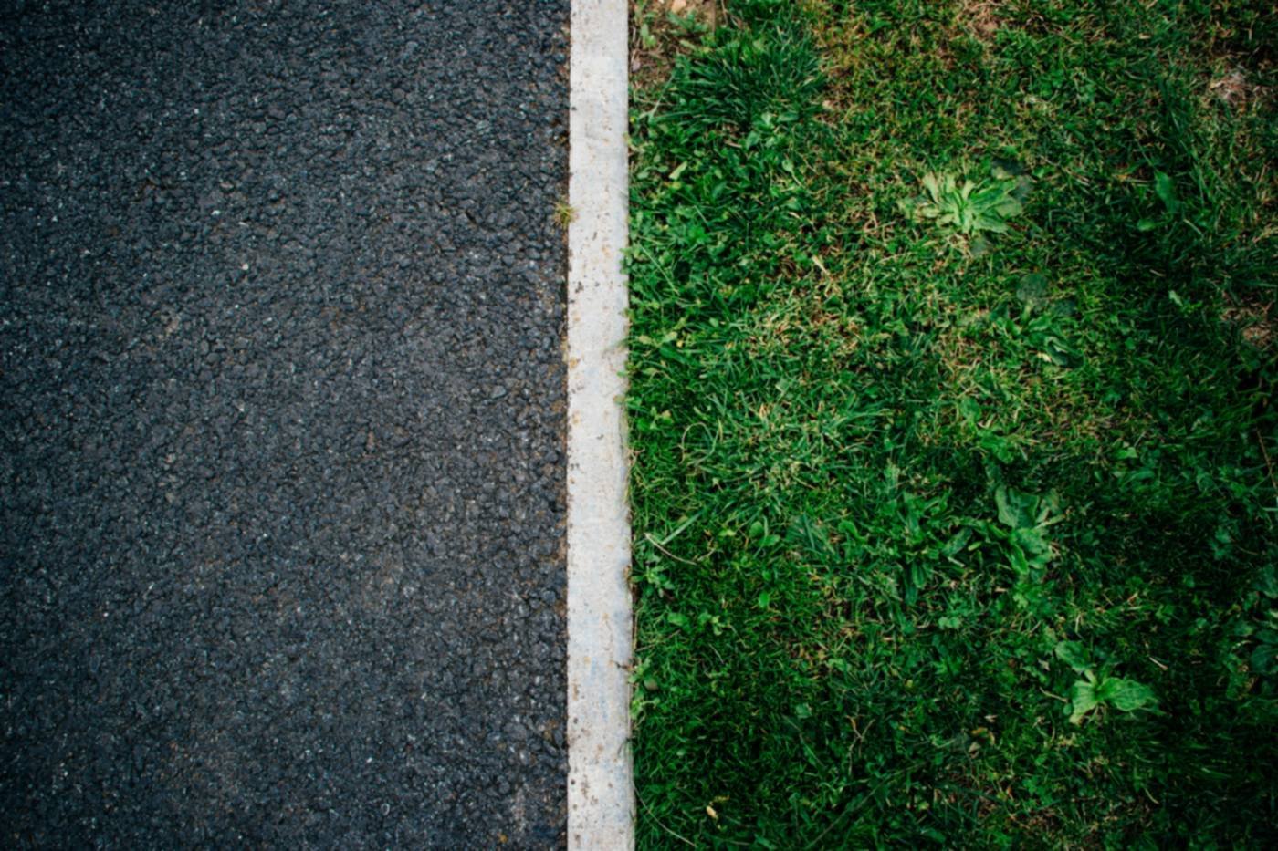 Tarmac with a kerb edge beside a lawn