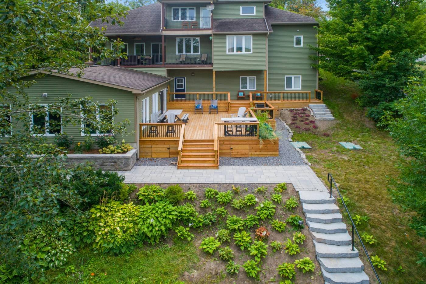 A timber deck with steps down to a paved garden path